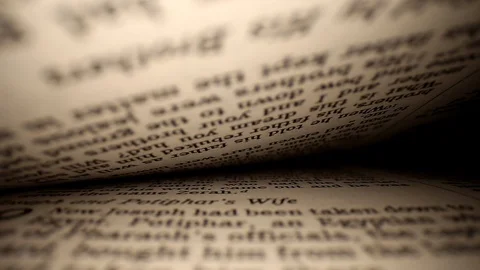 Pushing a lens into a book centered on page. Words eye view of the pages. Stock Footage 111294577