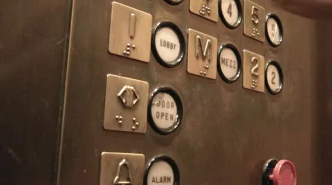 Pushing Lobby Button in Elevator Stock Footage