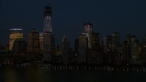 Pushing in on lower Manhattan at night over the water Stock Footage 135949105