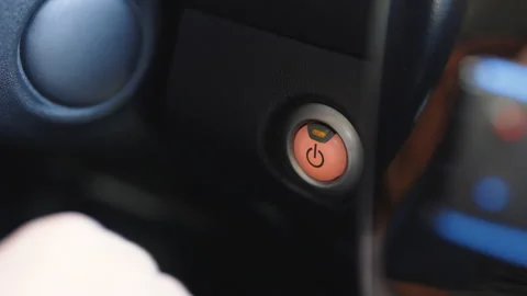Pushing Orange Power Ignition Button to Start Keyless Ignition Hybrid Car Video stock 196002638