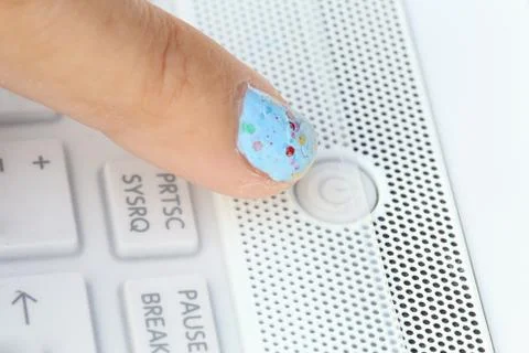 Pushing the power button on laptop computer Stock Photos