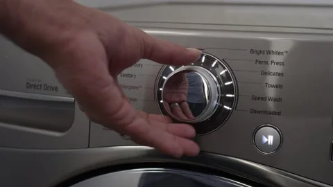 Pushing start button and turning settings knob on washing machine Stock Footage 147362411