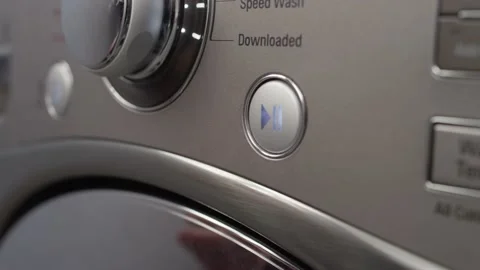 Pushing start button and turning settings knob on washing machine Stock Footage 147362426