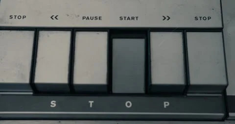 Pushing the start button of a vintage tape recorder in dim light Stock Footage 332472110