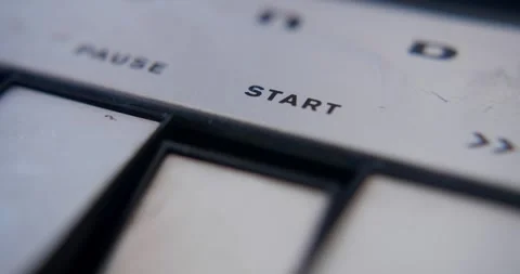 Pushing the start button of a vintage tape recorder Stock Footage 332472230