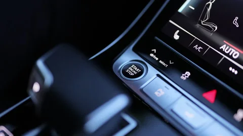Pushing start stop Button to start keyless ignition hybrid car electro engine Video stock 335691290
