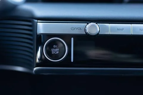 Pushing start stop Button to start keyless ignition hybrid car electro engine Stock Photos