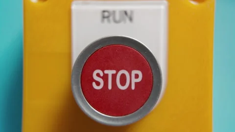 Pushing stop run button on a blue wall Stock Footage 318836060