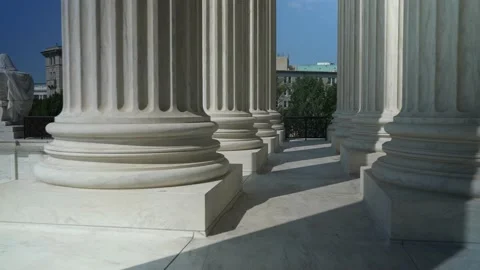 Pushing through very large towering columns in front of US Supreme Court Vídeos de archivo 211786907