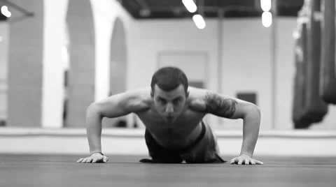 Pushing yourself to the limit. Young fit fighter doing pushups at the gym Video stock 58556235