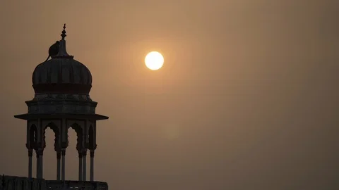 PUSHKAR, India - Grey Lagur monkey sat on building silhouetted against sunset Stock Footage 87332143