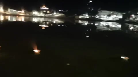 Pushkar's sacred lake at night. fire boats and dog Stock Footage 167892011