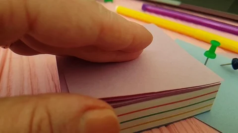 Pushpin, hand, notebook color paper Stock Footage 88047899