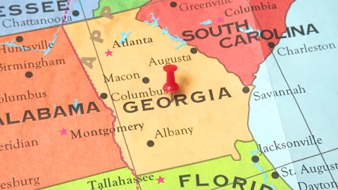 A pushpin is placed in the map of Georgia Vídeos de archivo 168656764