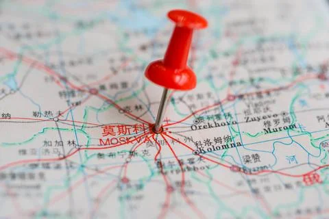 Pushpin stuck in the map Stock Photos