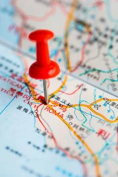 Pushpin stuck in the map Stock Photos