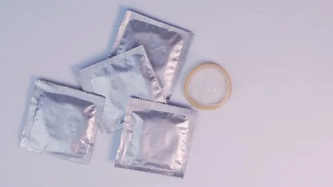 Put AIDS red ribbon nex to condoms Stock Footage 181067974