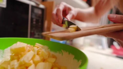 Put apple slices on dough for cake charlotte Stock Footage 144390817