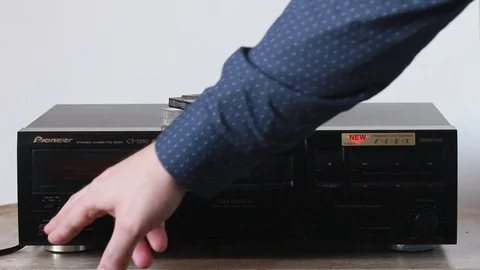 To put audio cassette Stock Footage 88989232