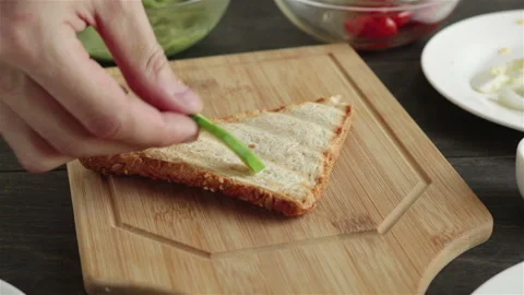 Put avocado slices on bread making sandwich Stock Footage 130366110