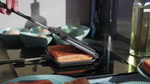 Put bread on a hot plate Stock Footage 320669825