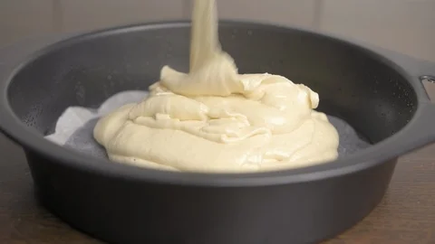 Put cake dough in a baking form. Close up. Stock Footage 94035645