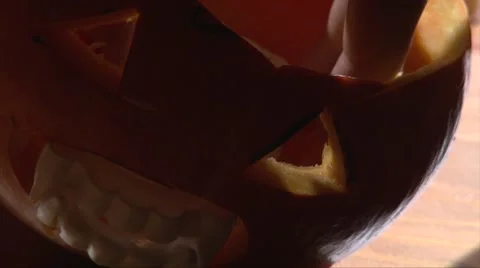 Put candle in and out of Jack O' Lantern halloween lamp, high angle Stock Footage 67897586