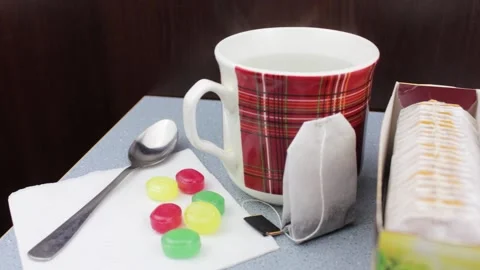 Put candy canes next to a cup of and tea. Tea with candies. Tea with sweets Stock Footage 195706434