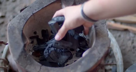 Put charcoal into the stove. Stock Footage 252288737