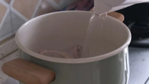 Put The Chicken Leg Into The Pot And Pour Water Into It- Close Up Stock Footage 244933488