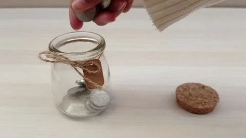 Put a coin in the glass Stock Footage 139429878