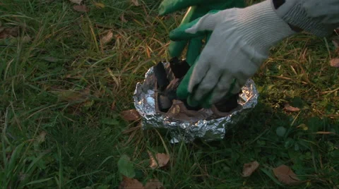 Put a content with a charcoal for barbecue in the hand made portable brazier Stock-Footage 63211528