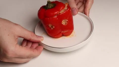 Put the cooked stuffed peppers with meat and rice on a white plate. Video stock 281828135