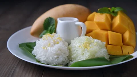 Put Crispy Mung bean on Coconut Flavored Sticky Rice with Ripe Mango Stock Footage 172206507