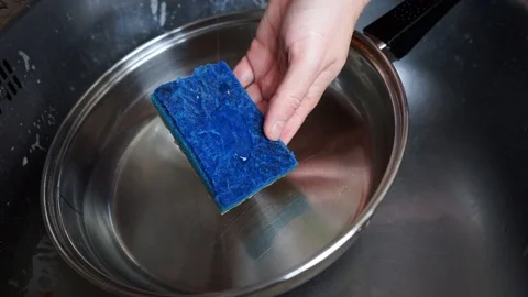 Put detergent on a sponge in a stainless steel sink Stock Footage 120033517