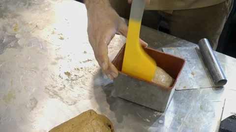 Put the dough into a baking dish with the hands in 4K Stock Footage 150724364