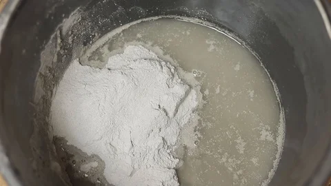 Put dry mortar in a bucket. Construction spatula with dry mix. Stock Footage 129697007