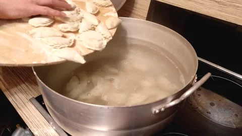 Put the dumplings in a pot of boiling water Stock Footage 244362097