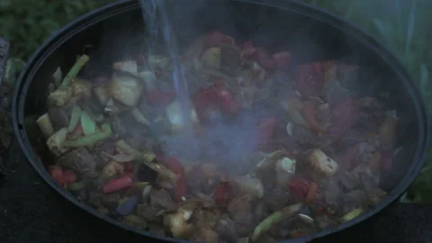 Put eggplants in a big pot with meat, onions, carrots, zucchini. all ingredients Stock Footage 146554527