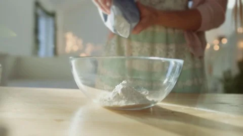 Put flour to the bowl in the kitchen Stock Footage 70942558