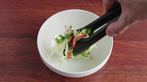 Put fresh salad with  cabbage cucumber tomatoes radish parsley corn in to  bowl Stock Footage 107932973