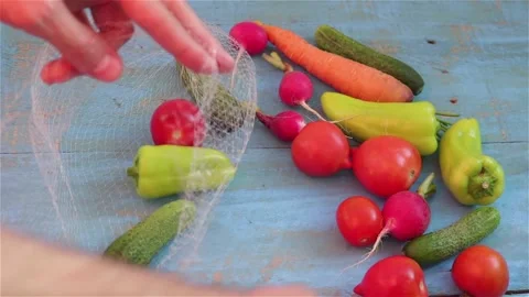 Put fresh vegetables in to reusable eco  mesh bag Stock Footage 147192913