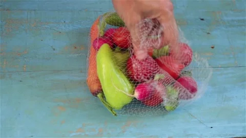 Put fresh vegetables from reusable  mesh bag on the table Stock Footage 130366030
