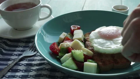 Put fried egg on toast bread in plate with fresh salad . healthy breakfast Stock Footage 102883394