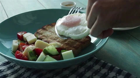 Put fried egg on toast bread in plate with fresh salad . healthy breakfast Stock Footage 104740221