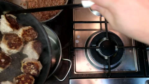 Put fried meatballs from frying pan to the pot Stock Footage 231769313