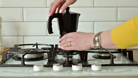 Put a geyser coffee maker on a gas stove to make coffee at home close up with Video stock 172035256