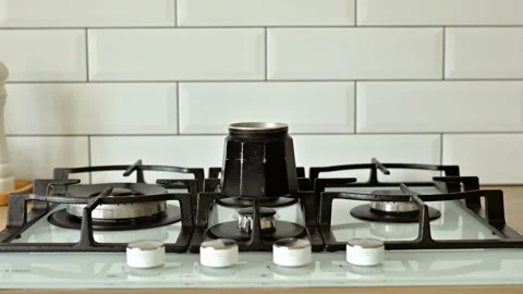 Put a geyser coffee maker on a gas stove to make coffee at home close up with Stock Footage 172043158