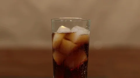 Put a glass of cola on the table Stock Footage 120797077