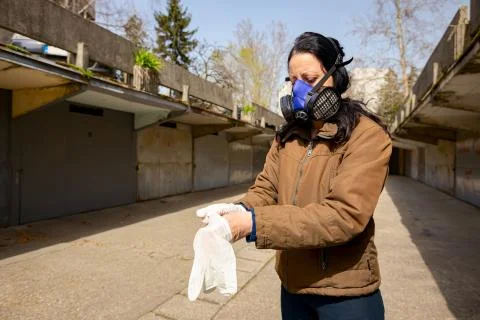 Put gloves on hands as wearing filter mask. Stock Photos